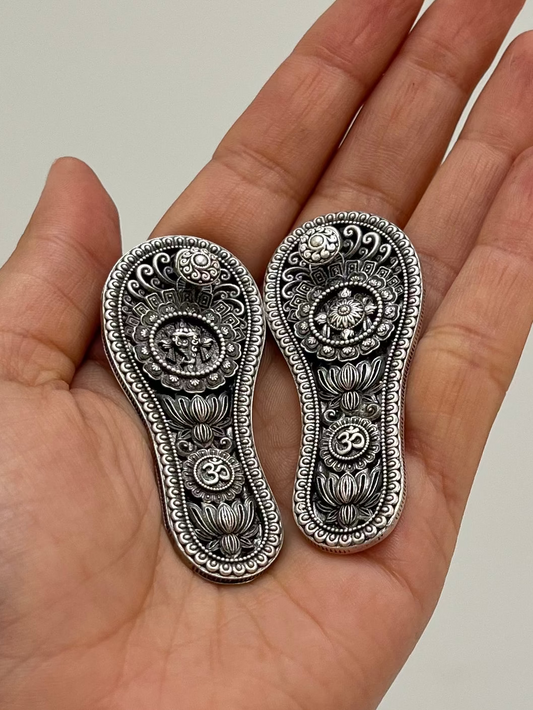 Front view 925 silver Charan Paduka pair – ornate holy footprints devotional item