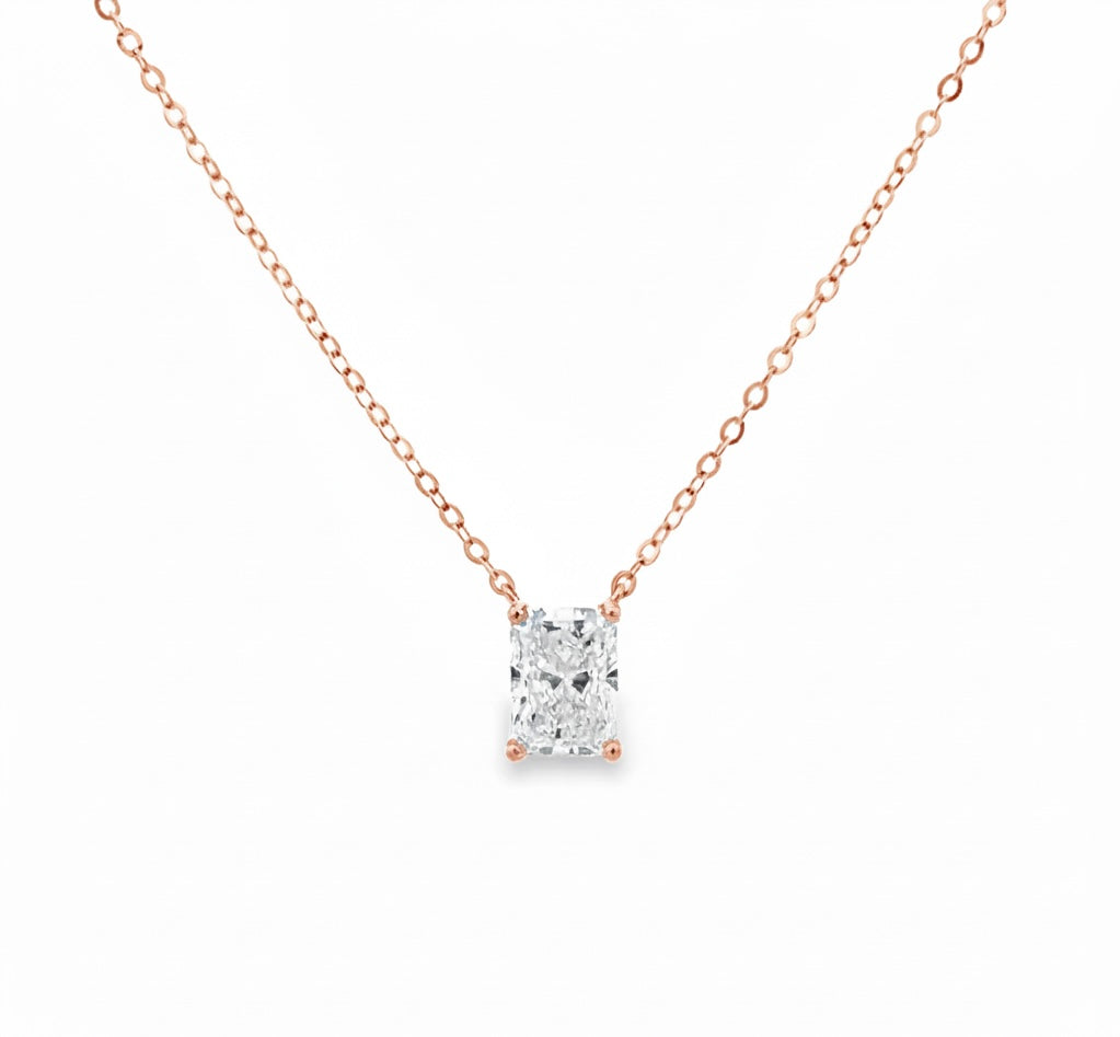 Rose gold necklace with a diamond pendant on a white background