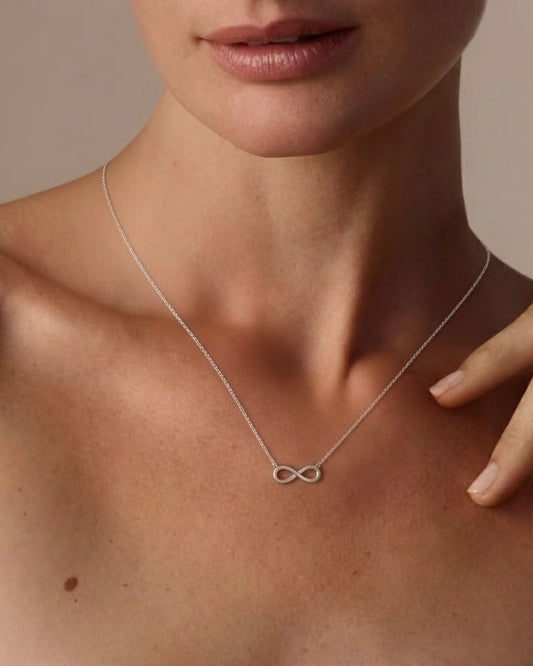 Model wearing "To infinity and beyond" infinity necklace – elegant symbolic jewelry