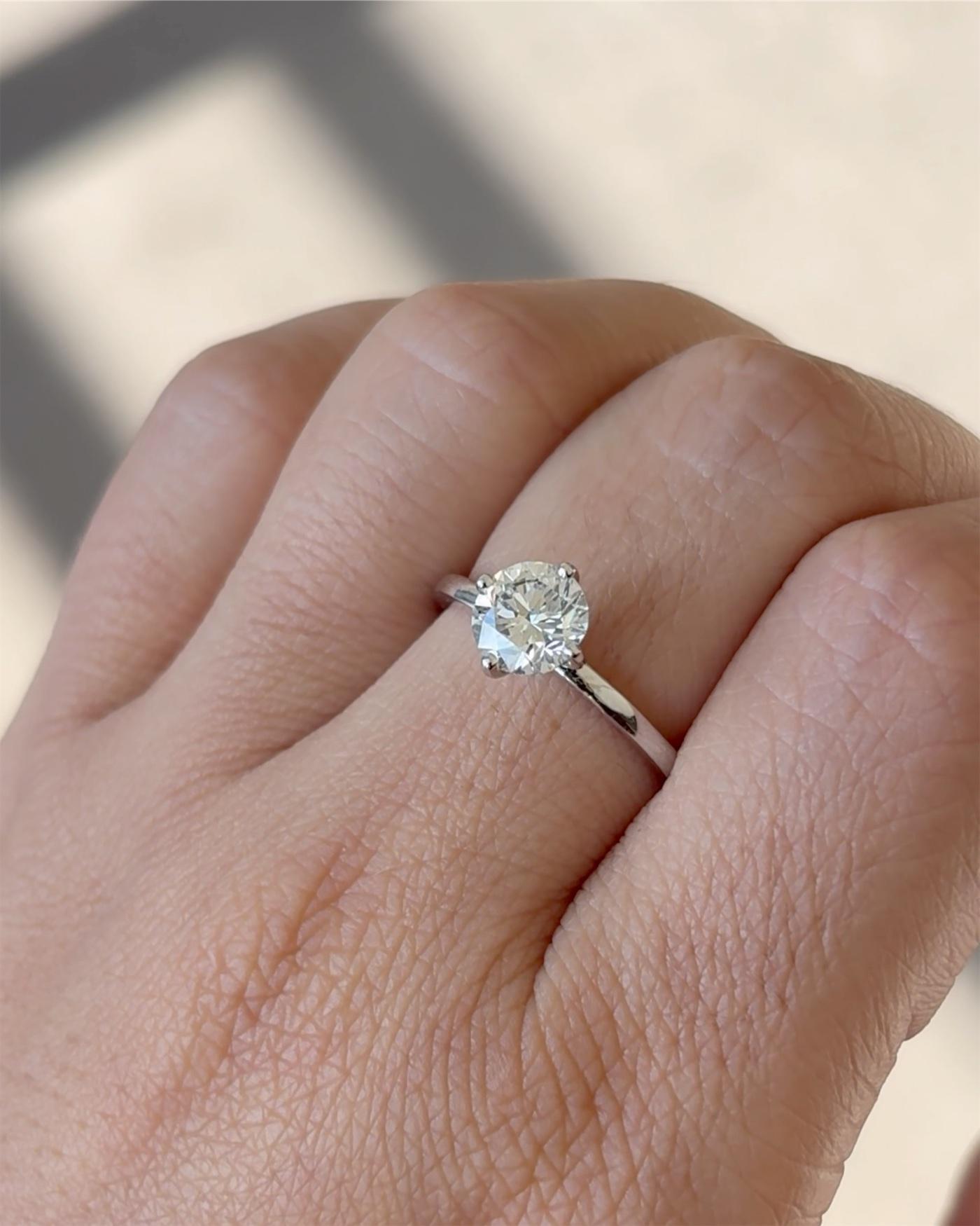 A round diamond solitaire, worn, in window light