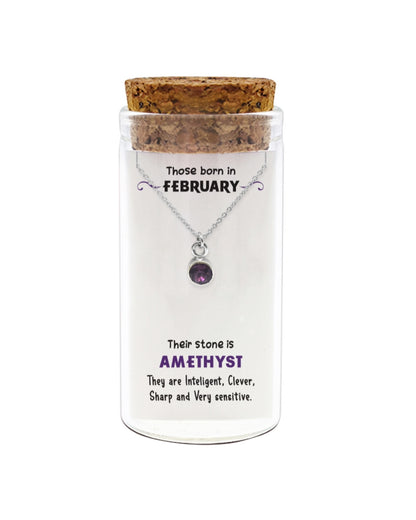 Necklace with amethyst stone in a glass jar with cork lid on a white background