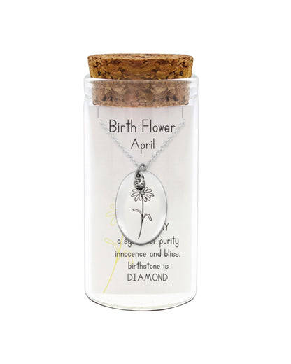 Birth flower necklace in a glass container with cork lid on a white background