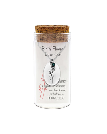 Necklace in a glass jar with a cork lid, featuring a December birthstone necklace.