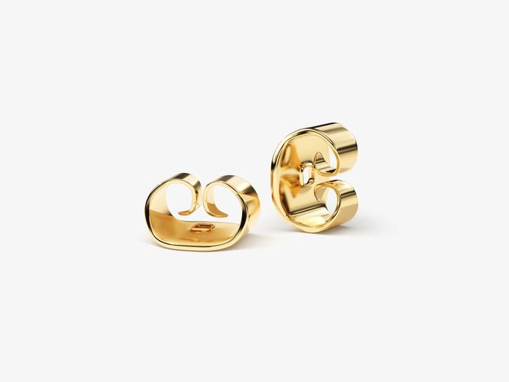 Two shiny gold PEAR SOLITAIRE EARRINGS with bold, modern designs featuring smooth, curved shapes are displayed on a plain white background. Each earring has an open, abstract looped form reminiscent of chic lab-grown diamond jewelry.
