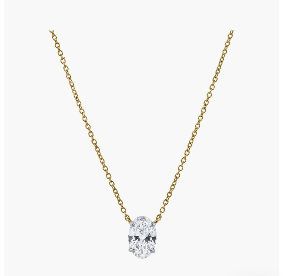 The OVAL SOLITAIRE NECKLACE is a delicate gold oval necklace with a single VS2 clarity lab-grown diamond pendant, shown centered on a plain white background.