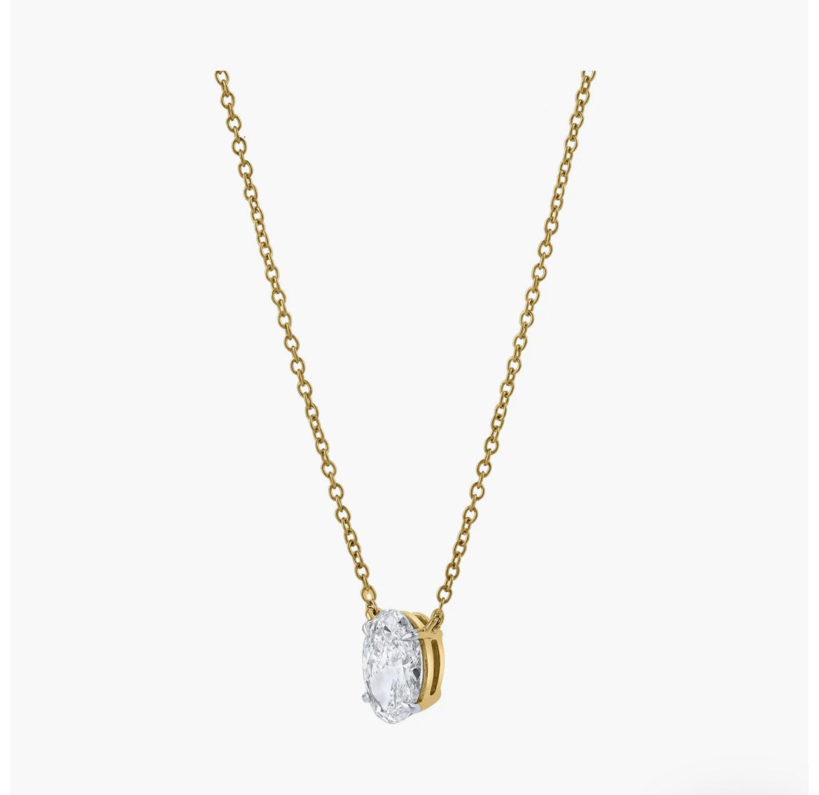 The OVAL SOLITAIRE NECKLACE features a minimalist gold chain with an oval-shaped lab-grown diamond of VS2 clarity in a bezel setting, showcased against a plain white background.