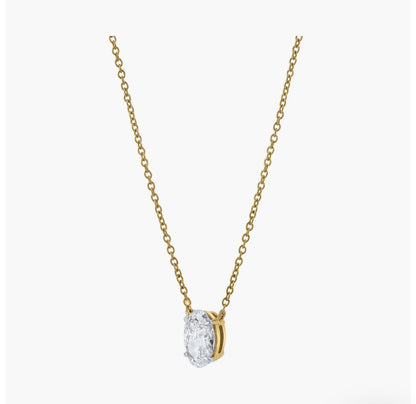 The OVAL SOLITAIRE NECKLACE features a minimalist gold chain with an oval-shaped lab-grown diamond of VS2 clarity in a bezel setting, showcased against a plain white background.