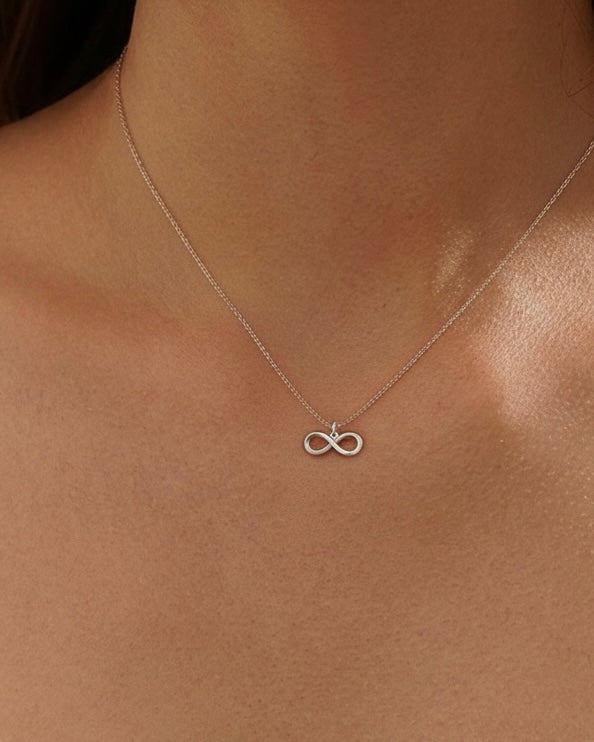 Model wearing "Forever" infinity necklace – elegant symbolic jewelry