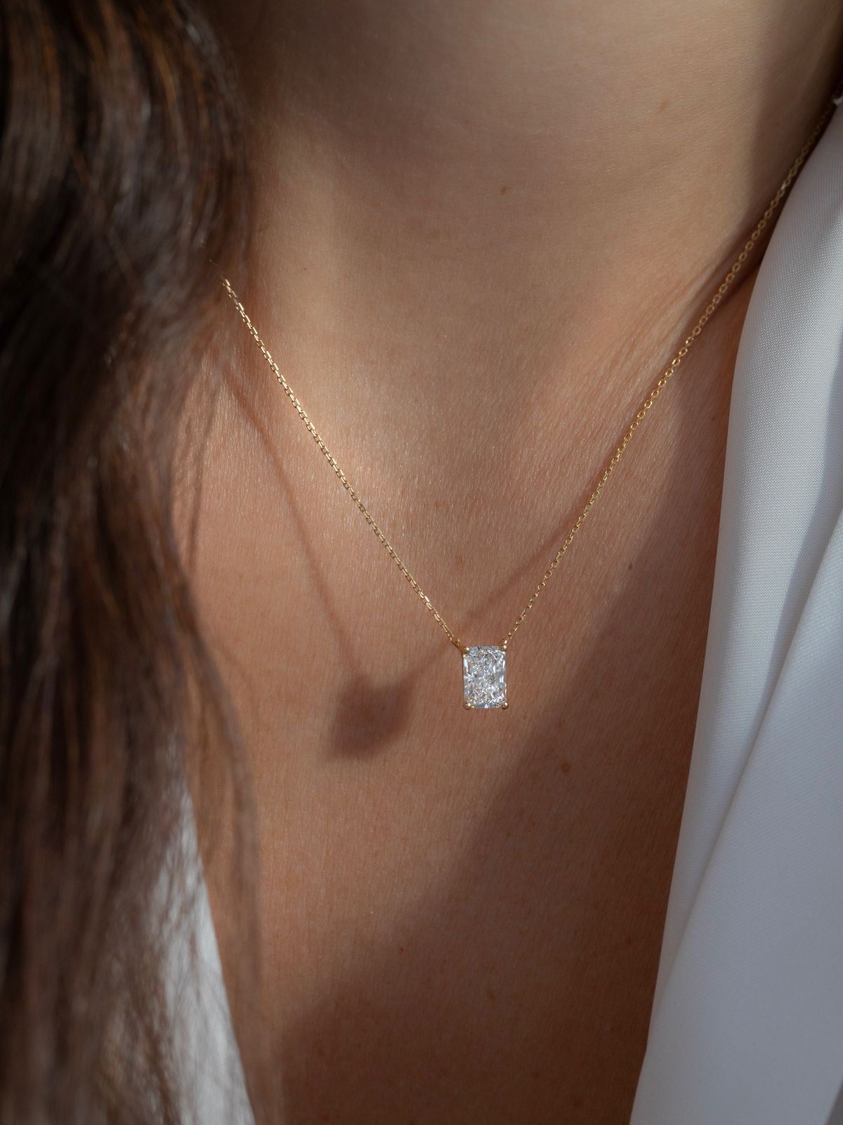 Radiant cut diamond necklace worn on neck – elegant gold diamond necklace