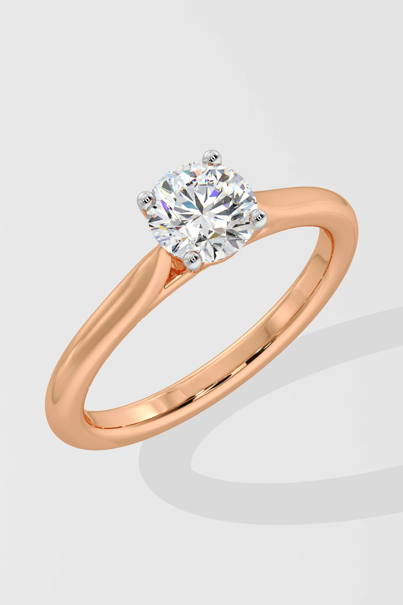 Rose gold ring with a diamond on a light gray background