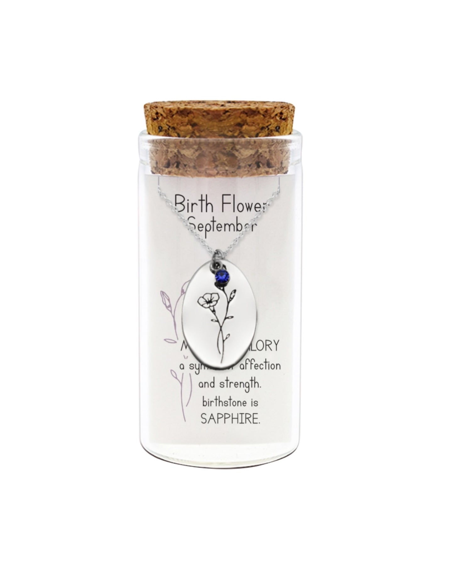 Glass jar with cork lid containing a necklace, featuring a sapphire gemstone, on a white background.