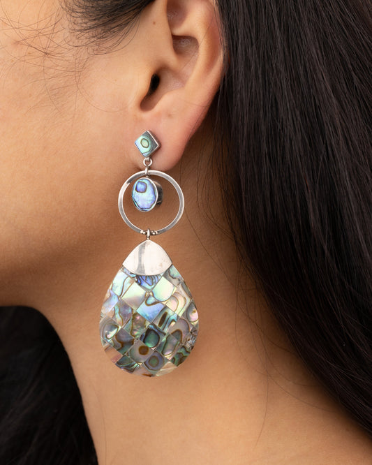 Earring with a teardrop-shaped design worn by a person