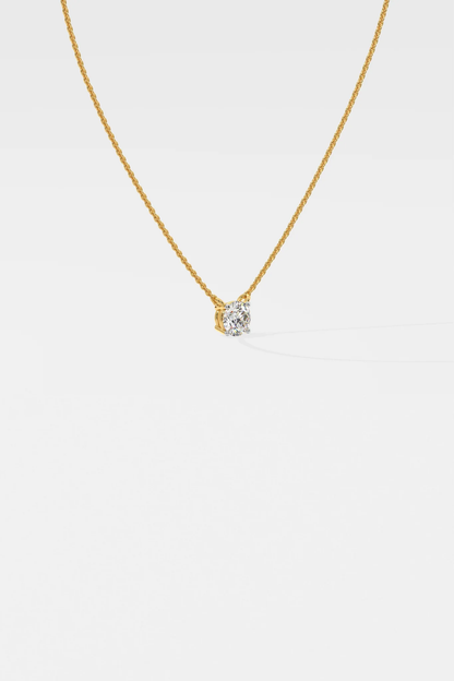 Side profile of custom round solitaire diamond necklace in gold highlighting setting and chain