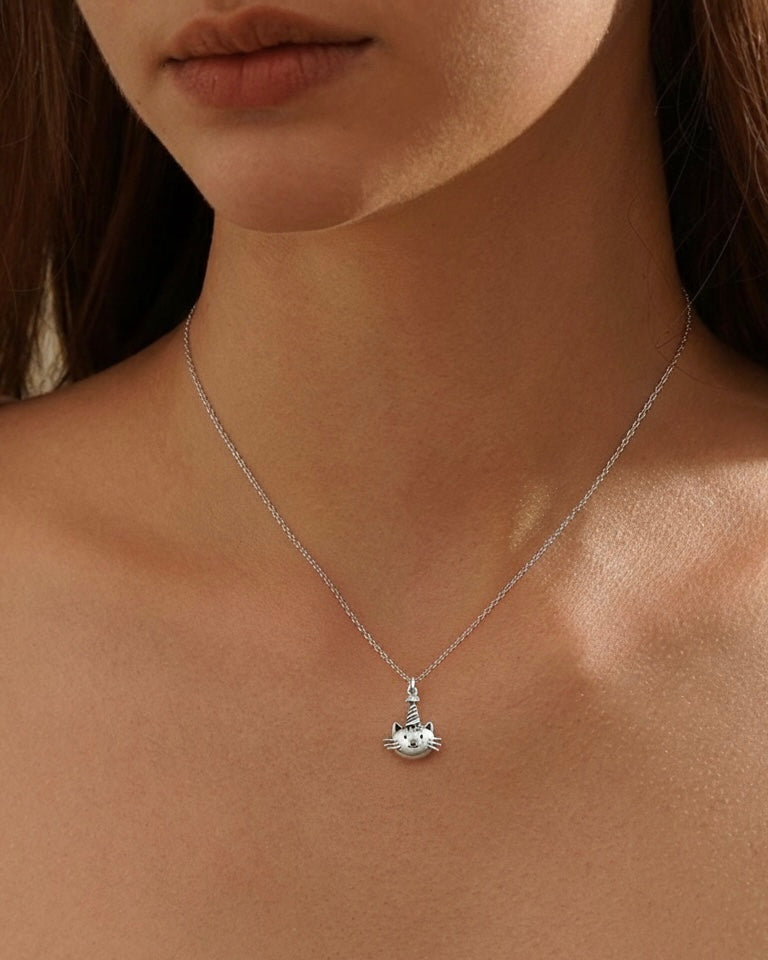 Model wearing birthday cat necklace with party hat – purrfect birthday charm