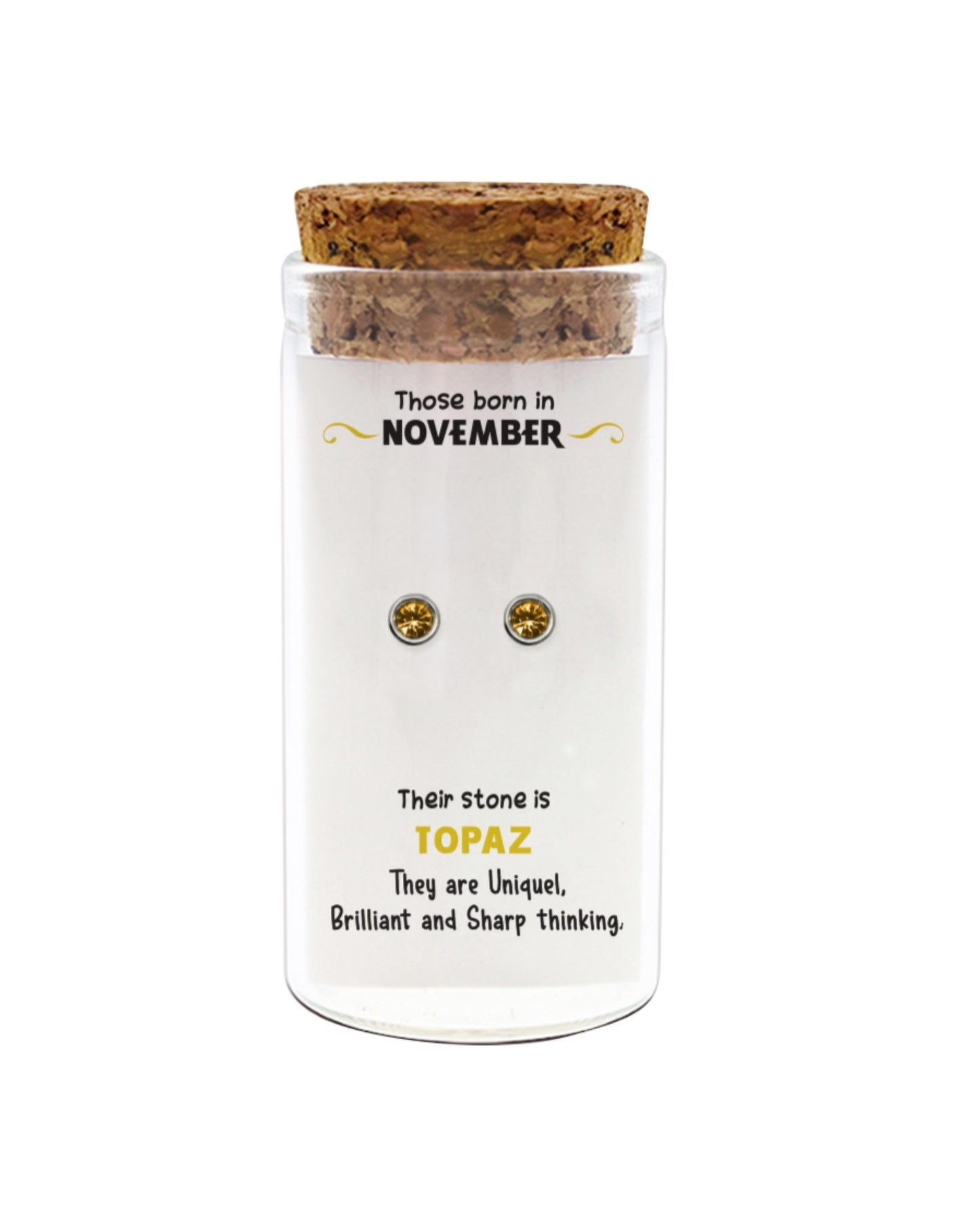 Jar of earrings with information about November-born individuals and topaz stones on a white background