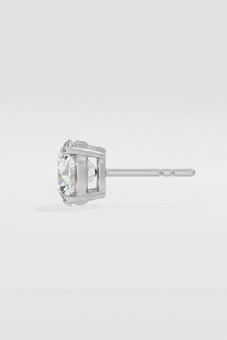 white gold stud earring with a clear gemstone on a light gray background