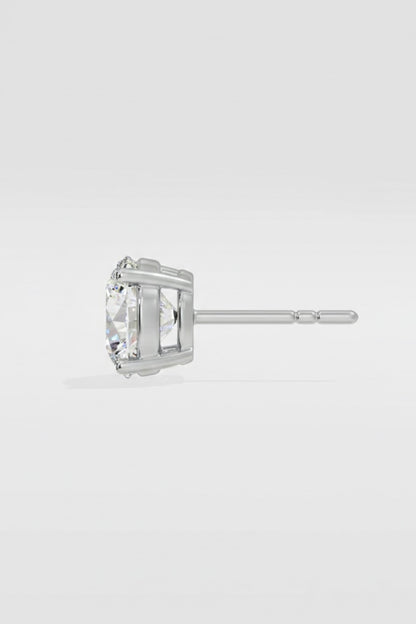 white gold stud earring with a clear gemstone on a light gray background