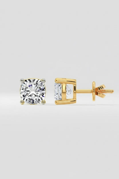 Gold stud earrings with Cushion Cut Solitaire on a light gray background
