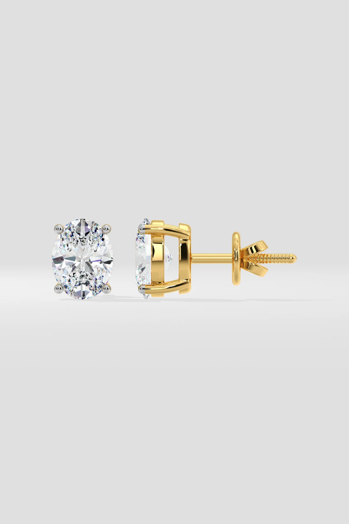 Gold  stud earrings on a light gray background