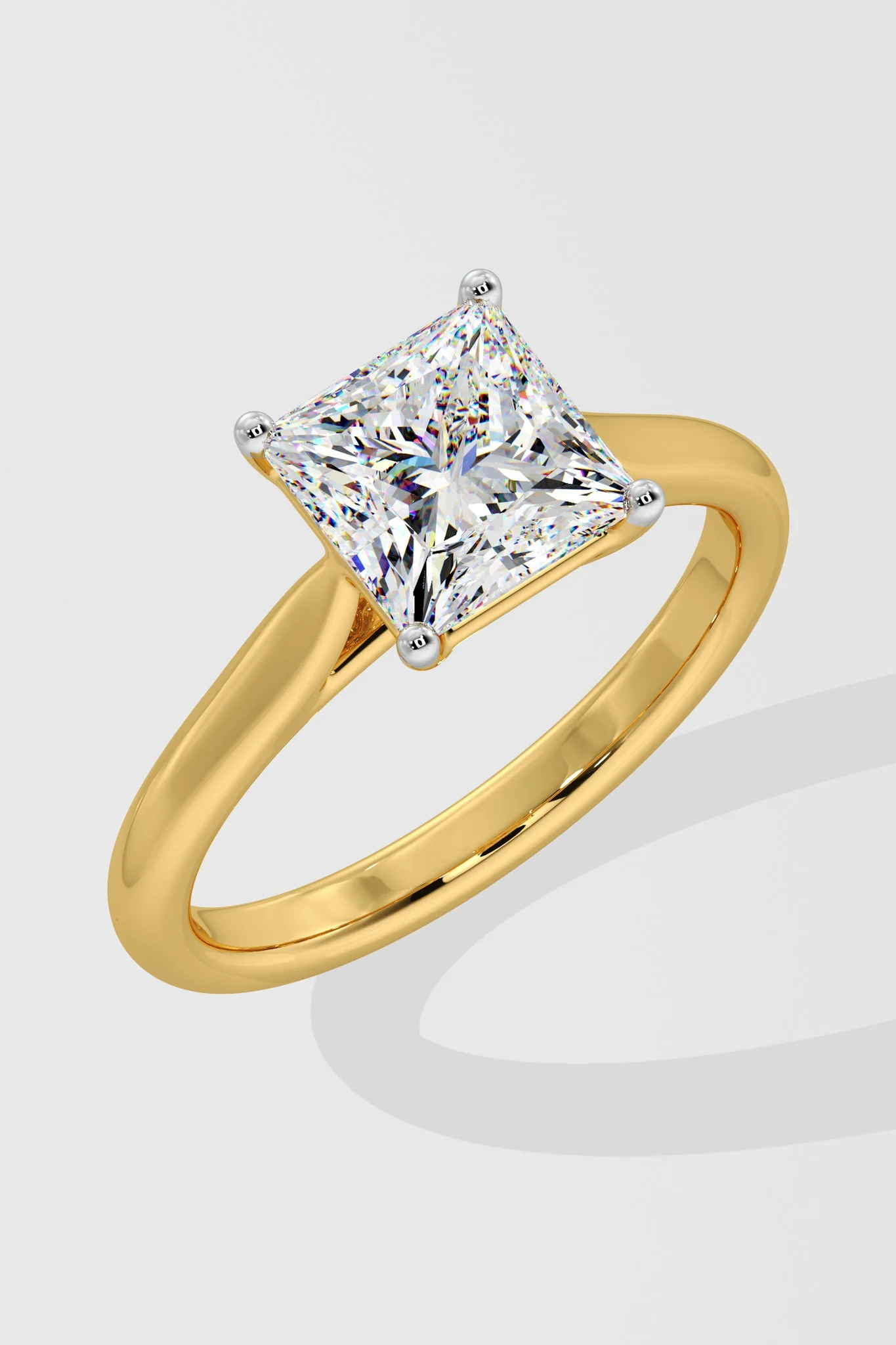 Gold ring with a large diamond on a light gray background
