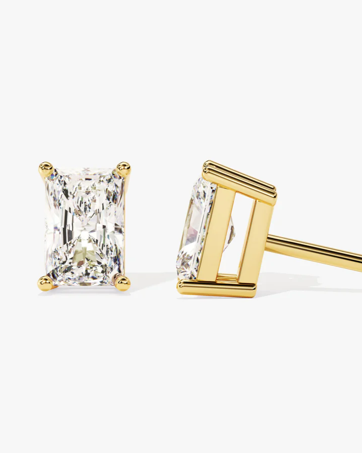 Gold stud earrings with radiant cut diamond on a white background