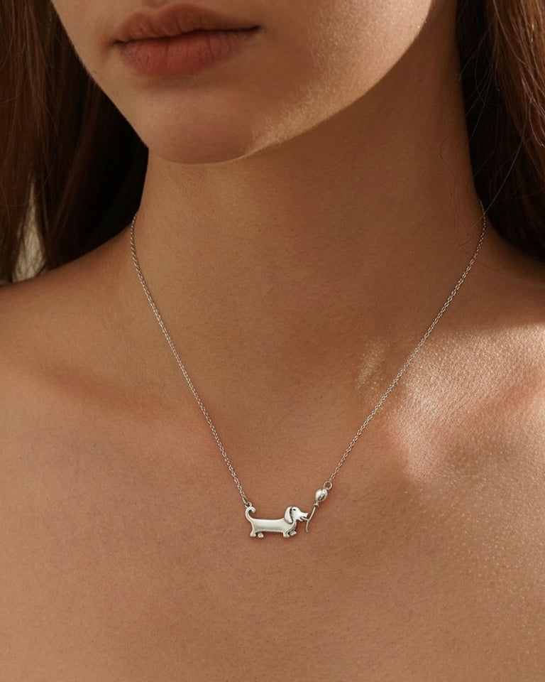 Woman wearing dachshund pendant necklace 925 silver – festive sausage dog jewelry on model