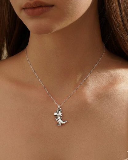 Model wearing dinosaur pendant necklace 925 silver – fun T-Rex birthday jewelry on model