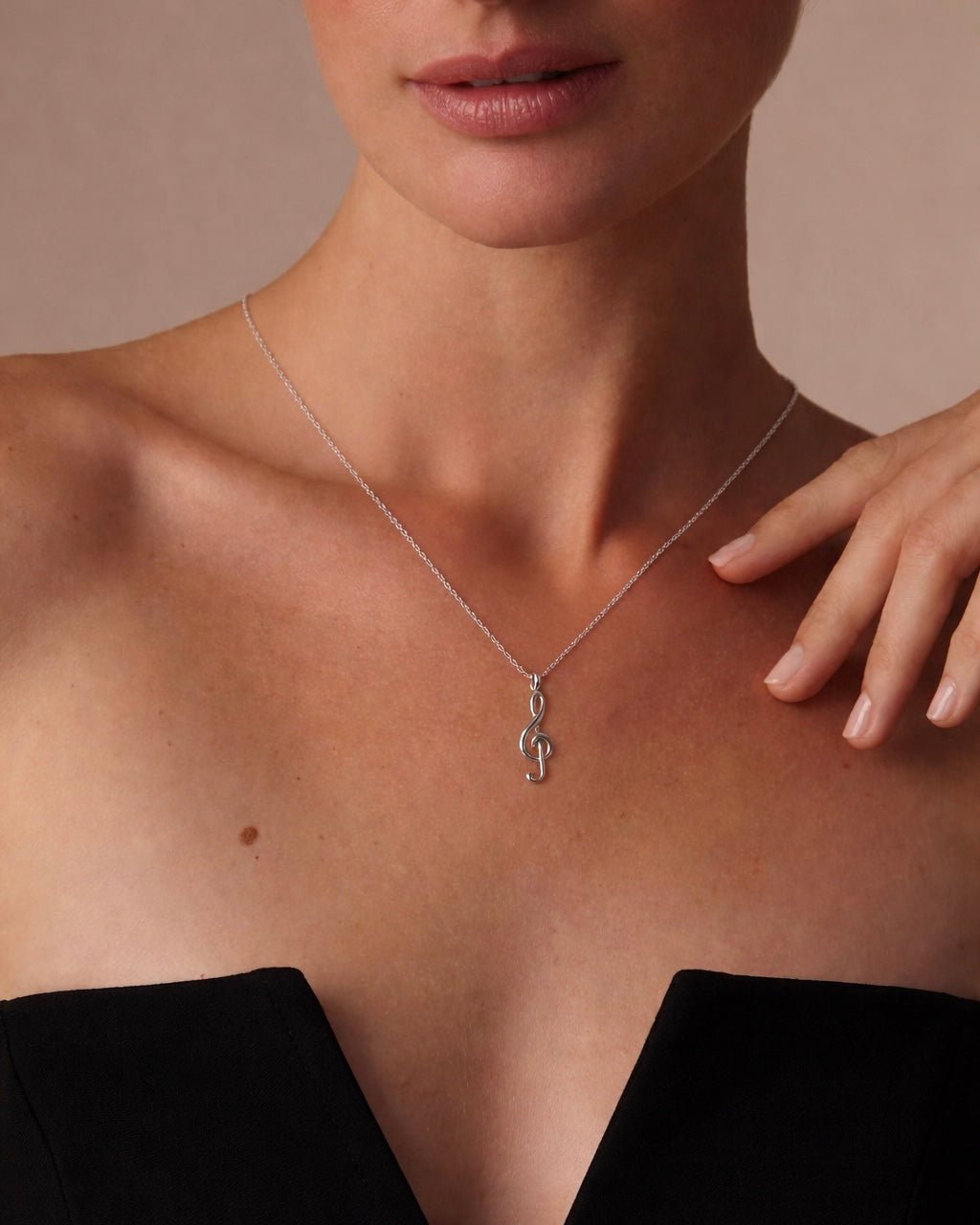 Model wearing music note necklace – delicate treble clef pendant
