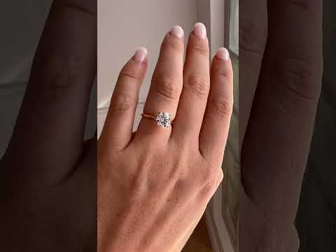 Hand wearing Round solitaire ring in gold with lab-grown diamond showing scale and sparkle