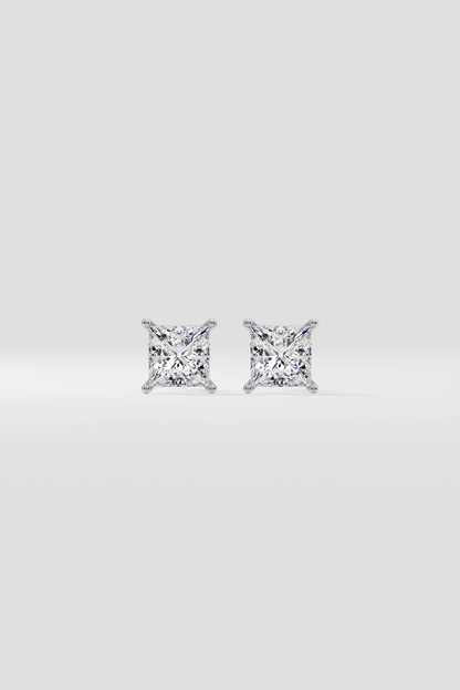 Pair of diamond stud earrings on a light gray background